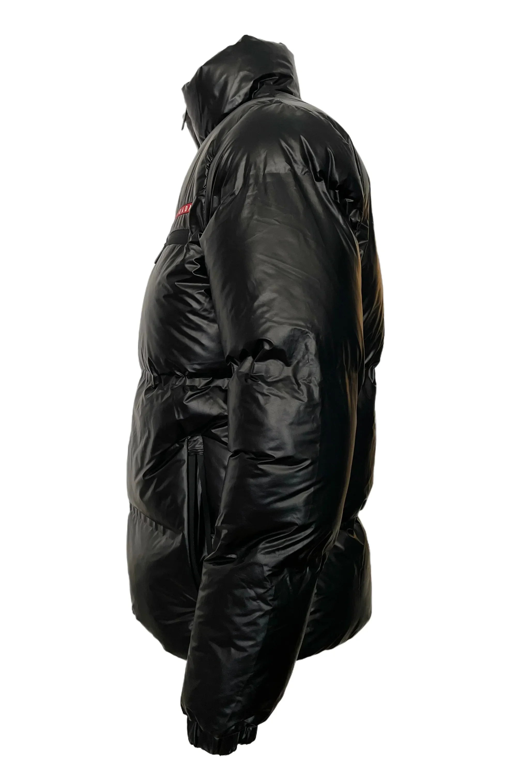 Black shiny puffer jacket with hood and elastic cuffs, side view on white background