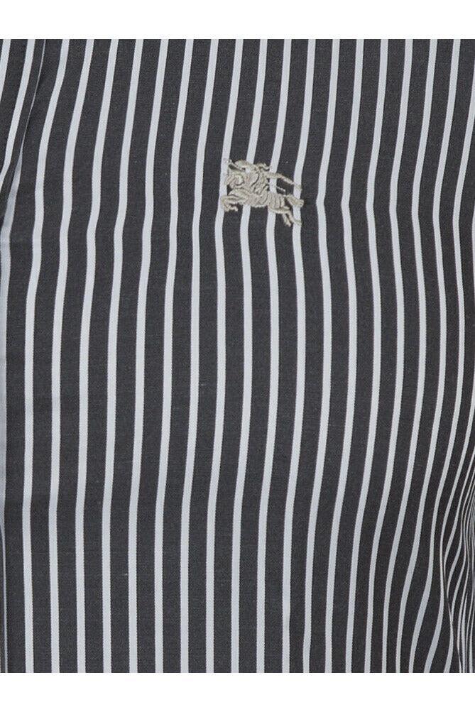 Close-up of black and white vertical striped fabric with embroidered white lion logo