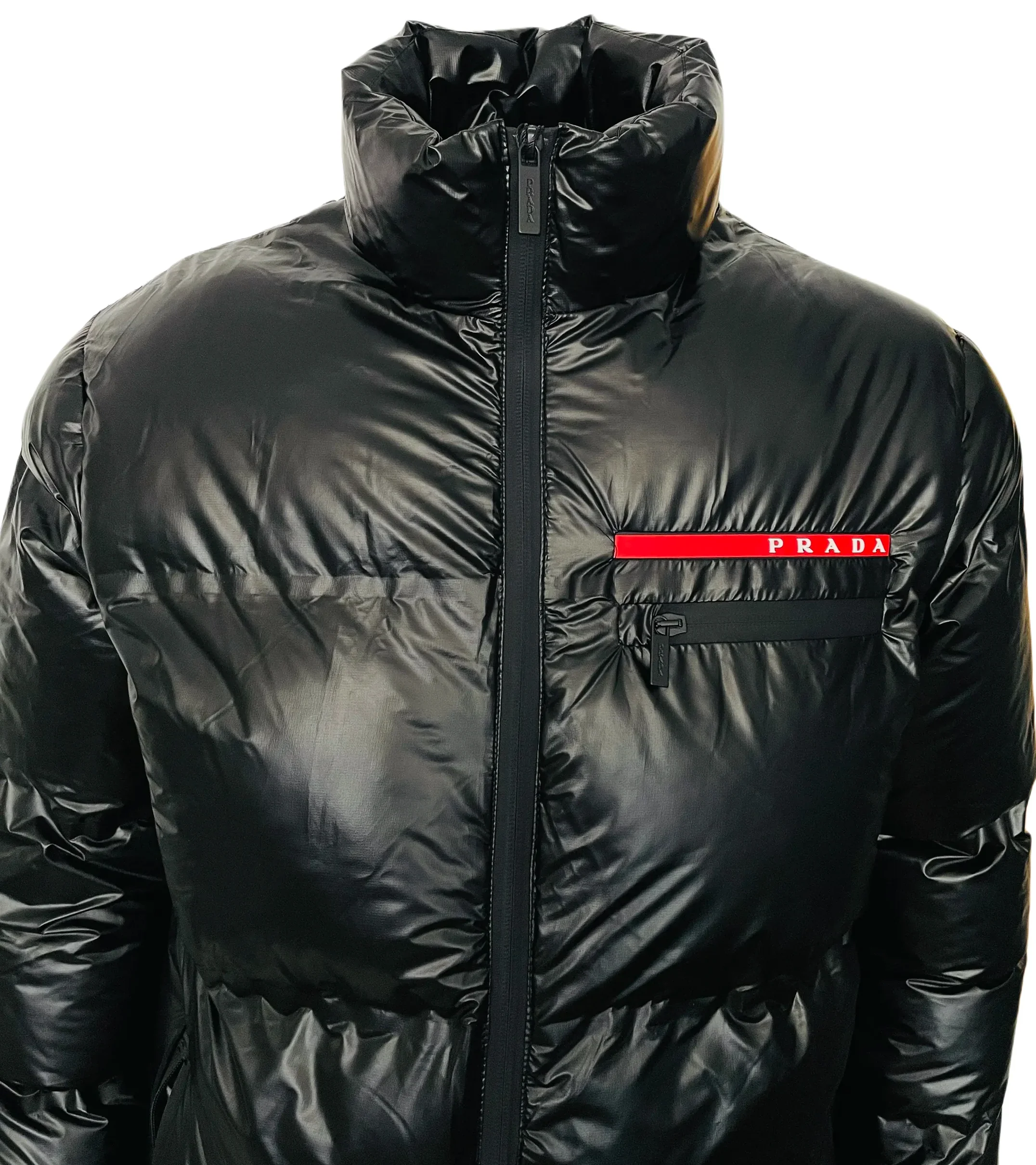 Black shiny Prada puffer jacket with high collar and chest pocket zipper on white background