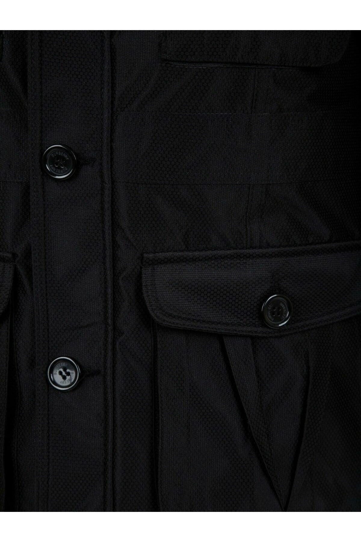 Close-up of black textured jacket with buttons and flap pocket detail